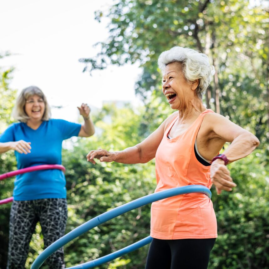 Senior woman exercising with a hula hoop Senior woman exercising with a hula hoop