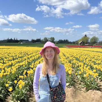 Laurel Bosma in yellow flowers with hat