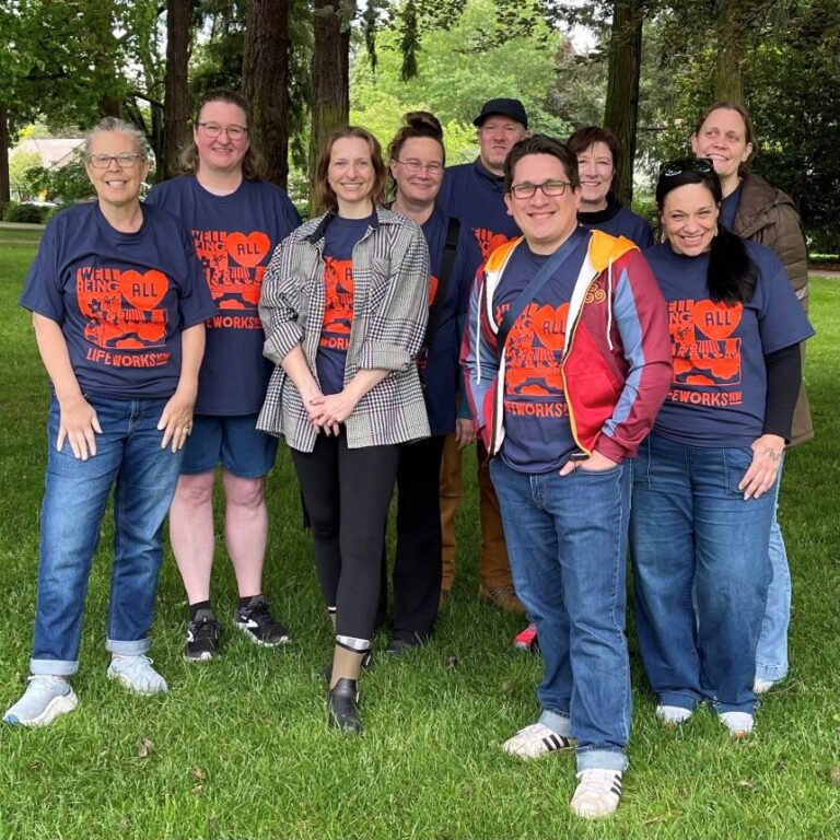 Some members of the LIfeWorks NW team stop for a photo at NAMIWalks Northwest in their event t-shirts.