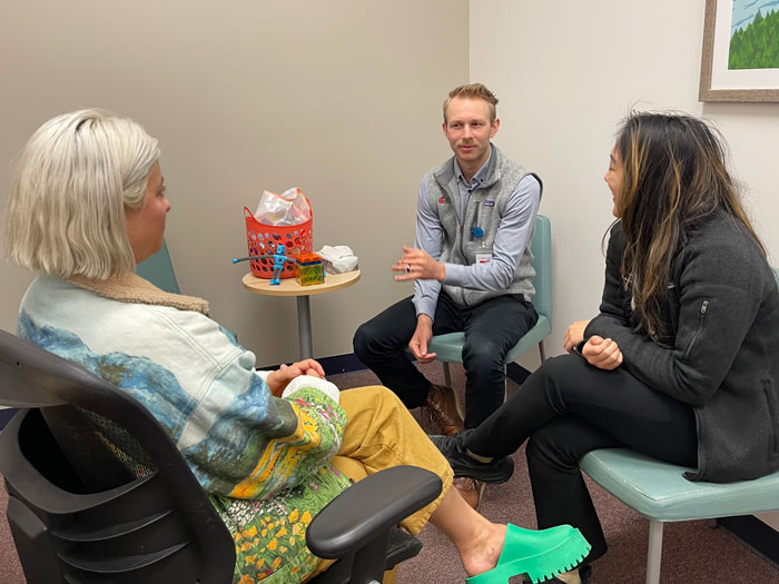 Dr.Taylor meets with two medical students in a treatment room at LifeWorks NW's NE MLK clinic.